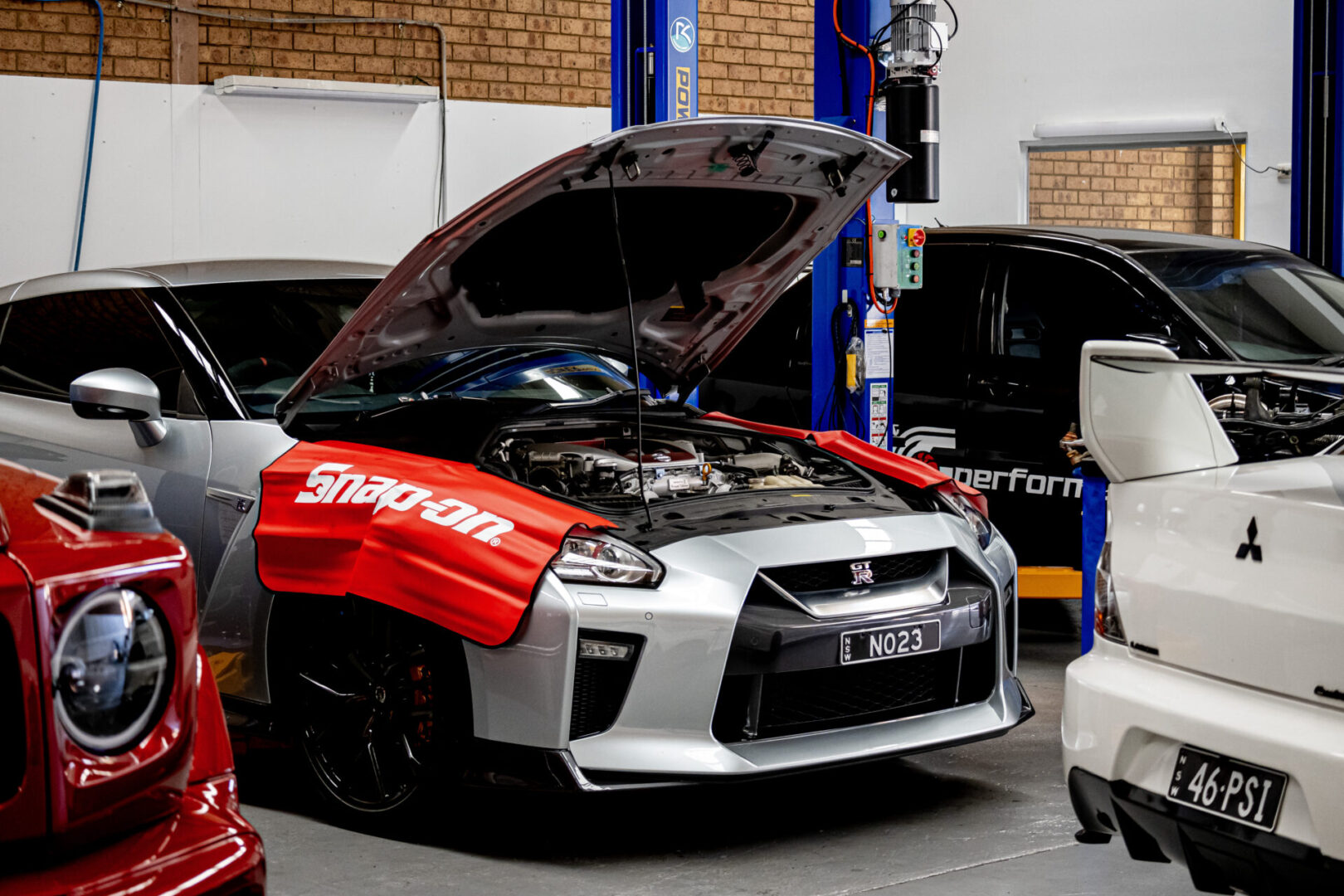 A car with its hood open and the engine bay of it.