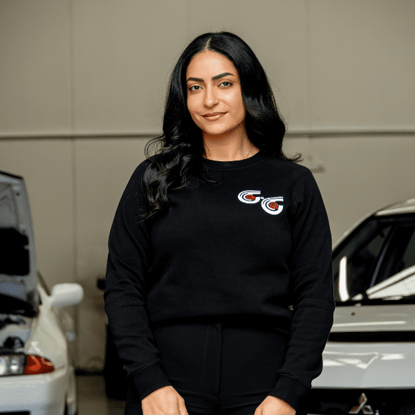 A woman standing in front of some cars