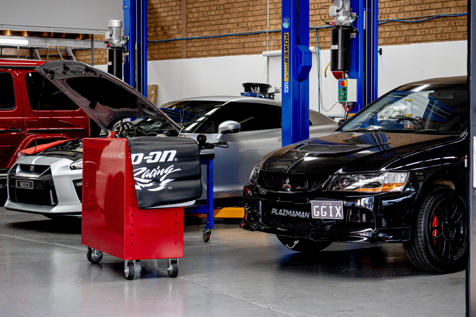 A car shop with two cars in the background.